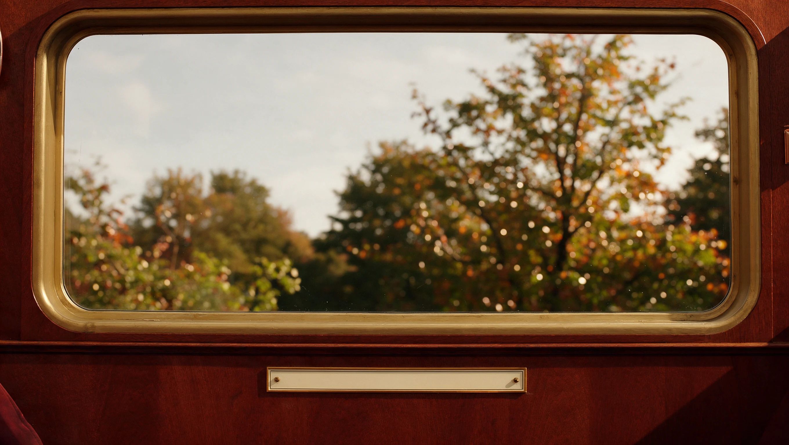 Vintage train window with walnut and brass trim